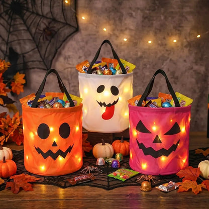 Orange, ghost and pink LED candy buckets with autumn leaves and pumpkins